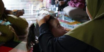 A group of people sitting around each other