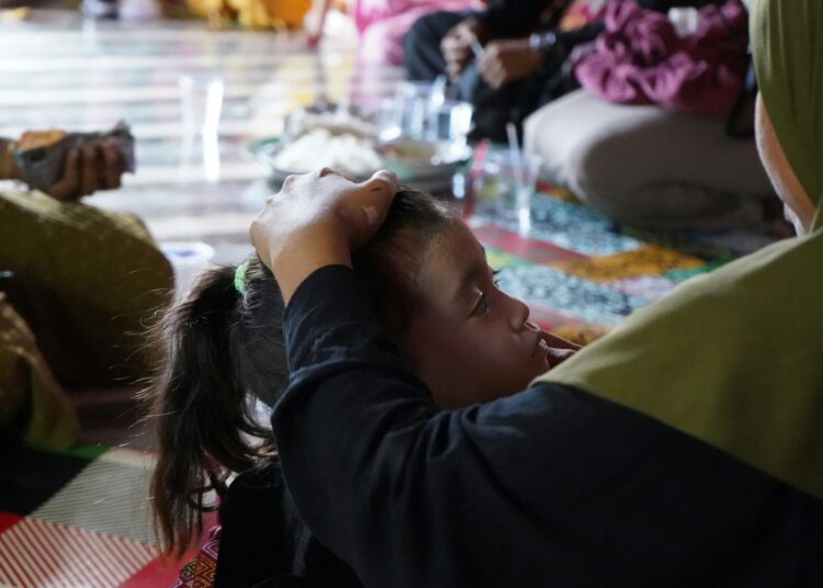 A group of people sitting around each other